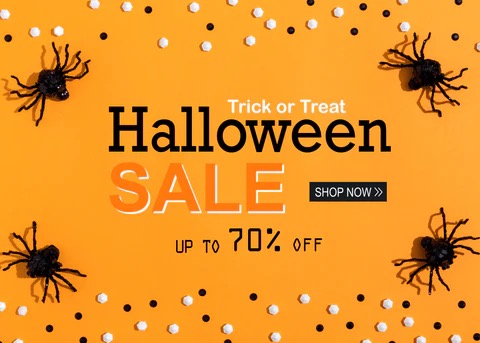 a sign stating that Halloween candy is on sale at 70% off.  orange background with spiders