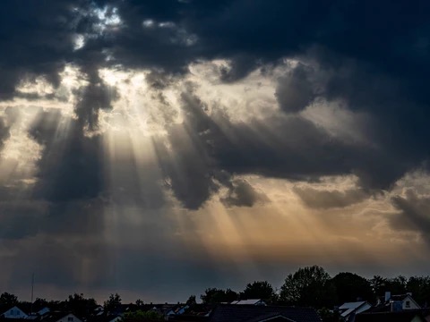 dark clouds with shafts of light breaking through