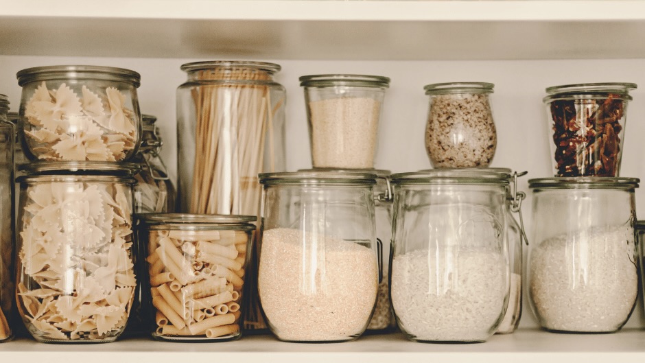 jars in a pantry filled with pasta, flour, etc.