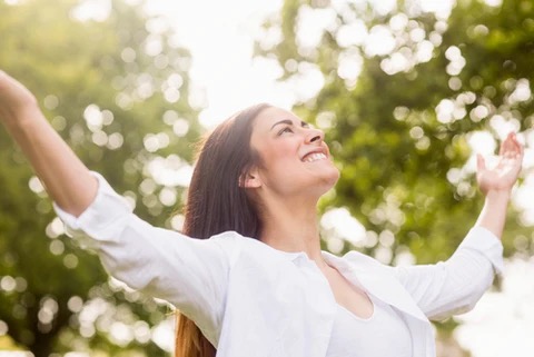 a woman with arms open and smiling.  It's a great day to be alive