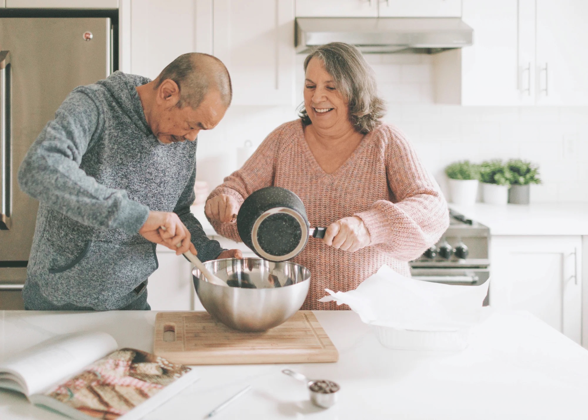 a man and woman cooking in the kitchen together
