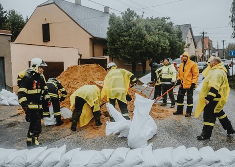 filling sandbags in the rain