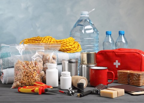 emergency preparedness supplies including water, food, flashlight, first aid