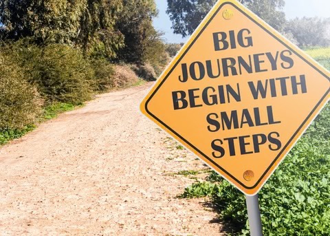 a path with a sign next to it that says "Big Journey Begins with Small Steps"