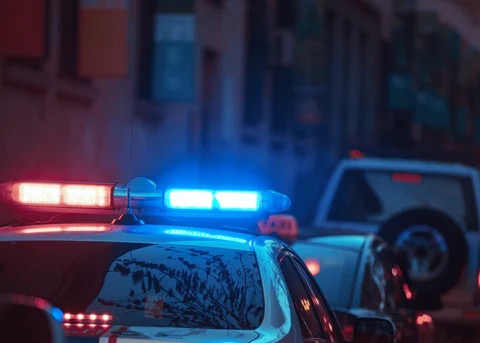 police car with emergency lights on at night