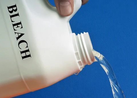 pouring bleach from a bottle