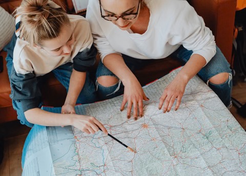 two females looking at a map together