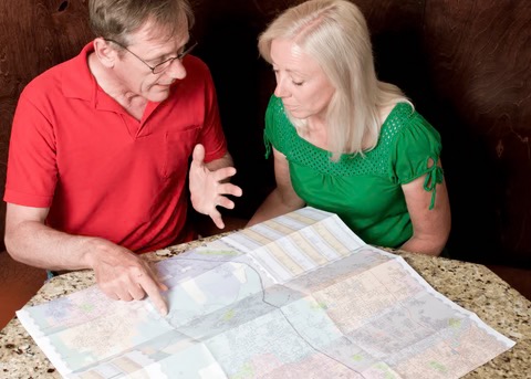 a man and woman looking at a map