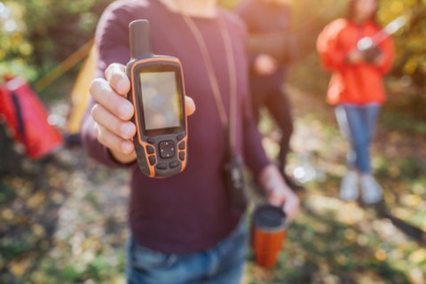 a man holding a satellite phone