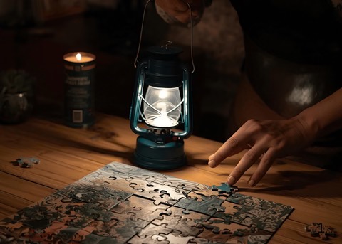 prepared peaceful home showing working a puzzle with lantern light