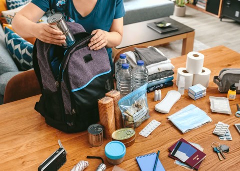 a woman putting together her emergency kit
