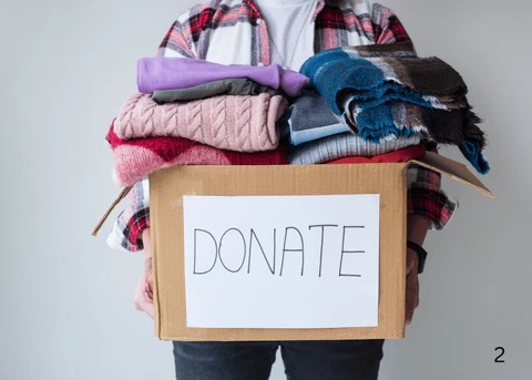 prepared home showing a woman holding a box of clothes to be donated