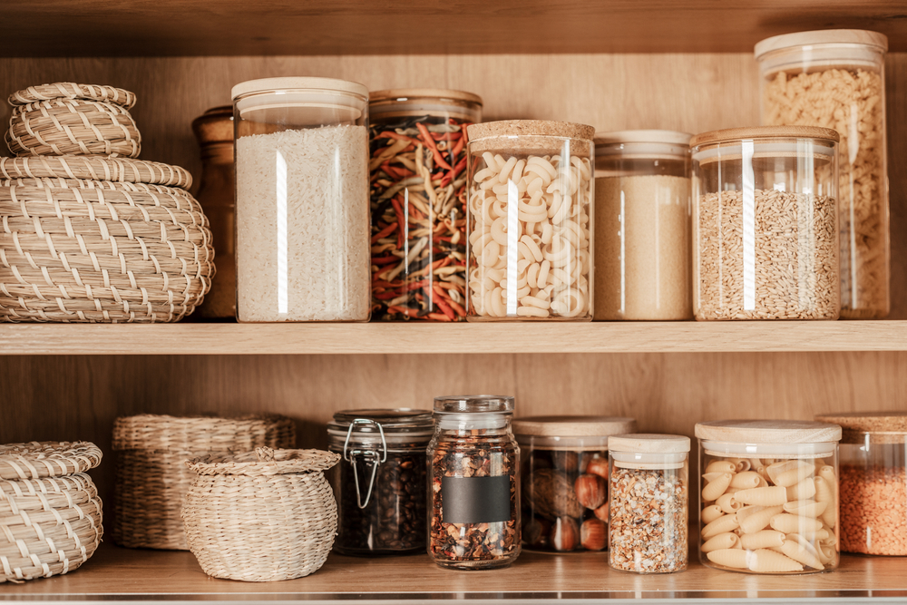 a pretty pantry filled with glass jars and baskets